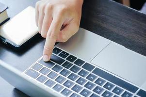 Male working with Laptop computer on the table photo