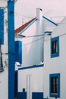 Traditional blue and white buildings in Ericeira, Portugal photo