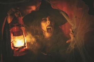 Witch With Lighted Lantern In Magic Fog photo