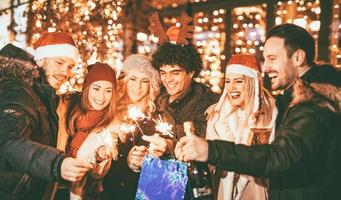 Friends Celebrating With Christmas Lighting Sparklers photo