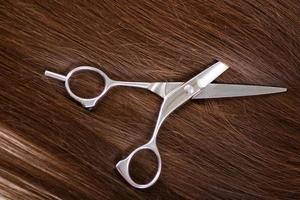 Closeup of scissors on hair photo