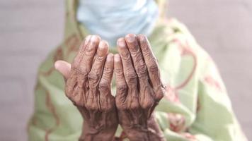 Elderly woman back of hands in close up held together video