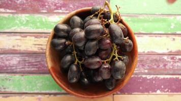 Red grapes in a bowl, close up top view video