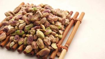 Handful of pistachios on a bamboo tray video