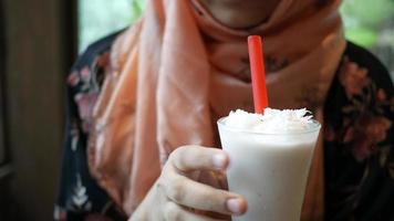 Woman drinks iced latte video