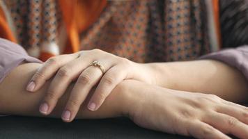 Close up of woman arms and hands, resting on the table video