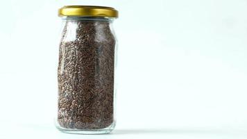 Small glass jar of whole flax seeds with lid video