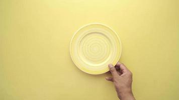 Yellow plate placed on yellow table video