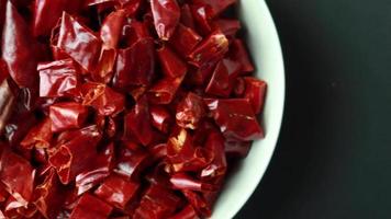 Dried chili peppers on  aplate, close up video