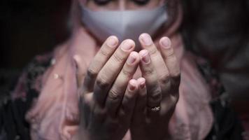 Muslim women with mask and head scarf praying video