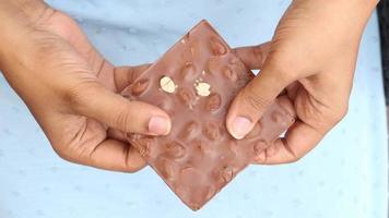 Breaking a nut chocolate bar with both hands video