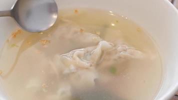 A clear soup with dumplings, close up video