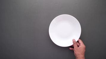 White plate placed on dark table video