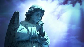 The statue of an Angel on time lapse blue clouds - Loop video