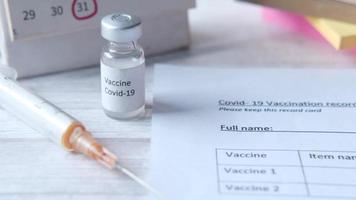 Covid 19 vaccine, calendar and a form on the table video