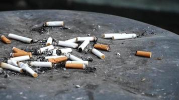 Cigarette butts littered about video