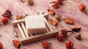 Soap bar on a wooden stand, orange dried leaves video