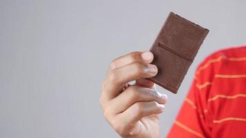 Man holds a chocolate bar video