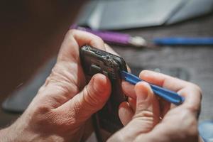 Man Repairing A Mobile phone photo