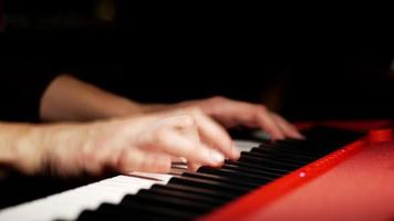 Playing a keyboard close up on hands video