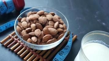 Light weight dumbbell with measuring tape a bowl of whole almonds and glass of milk video