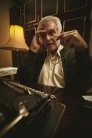 Pensive Retro Senior Man Writer photo