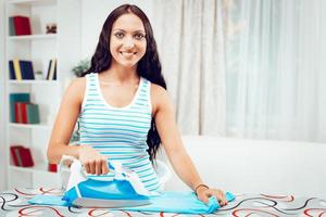 Young Maid Ironing photo