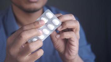 Getting a pill out of the blister, close up video