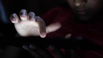 Close up of person using a touch screen tablet in the dark video