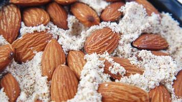 A bowl of almonds and almond flour close up video