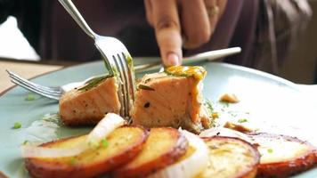 Having a healthy lunch, with grilled salmon and sweet potatos video