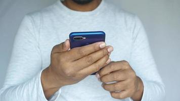 Man holds smartphone video