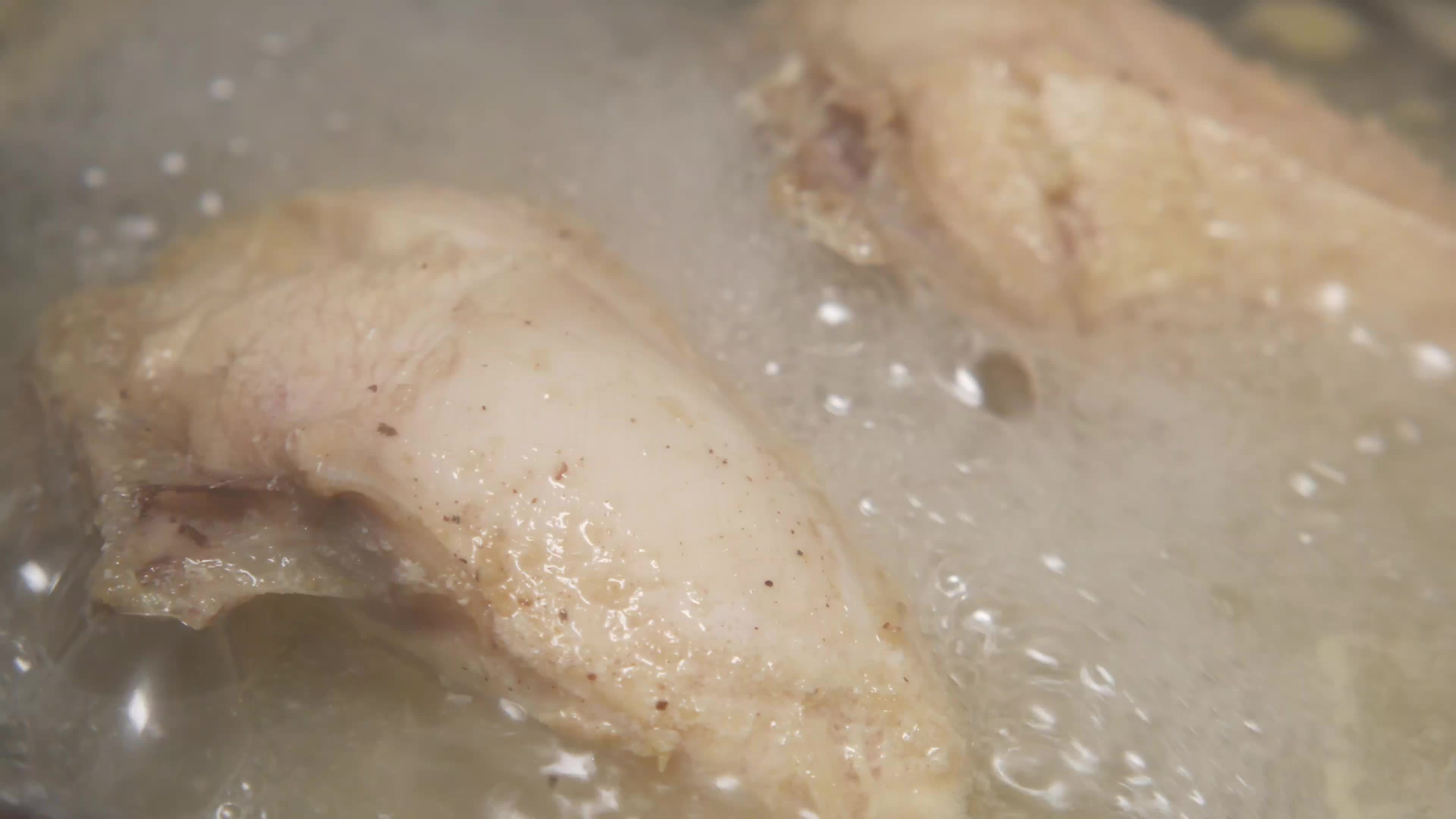 Close up of frying chicken, oil bubbles 14070799 Stock Video at Vecteezy