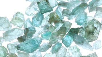 Apatite jewel stones heap up texture on light white isolated background. Moving right seamless loop backdrop. video