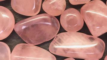 Rose quartz jewel heap texture. Pile mineral pebbles background. Moving right seamless loop backdrop. video