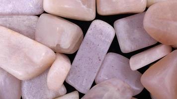 Sunstone heap jewel stones texture background. Moving right seamless loop backdrop. video