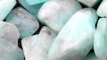 Amazonite jewel heap texture. Pile mineral pebbles background. Moving right seamless loop backdrop. video