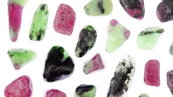 Ruby zoisite rare jewel stones texture on light white surface background. Moving right seamless loop backdrop. video