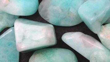 Amazonite jewel heap texture. Pile mineral pebbles background. Moving right seamless loop backdrop. video