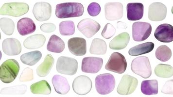 Fluorite jewel stones set texture on white light isolated background. Moving right seamless loop backdrop. video