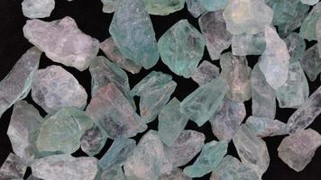 Apatite jewel stones heap up texture on black background. Moving right seamless loop backdrop. video