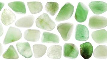 Green Aventurine jewel heap set texture on white light background. Moving right seamless loop backdrop. video