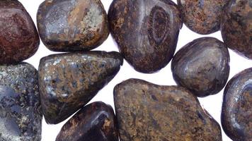 Bronzite heap jewel stones texture on white light background. Moving right seamless loop backdrop. video