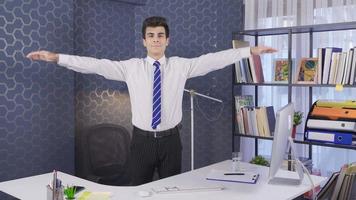 Businessman doing physical exercises in the office. Businessman working out his muscles doing exercises. video