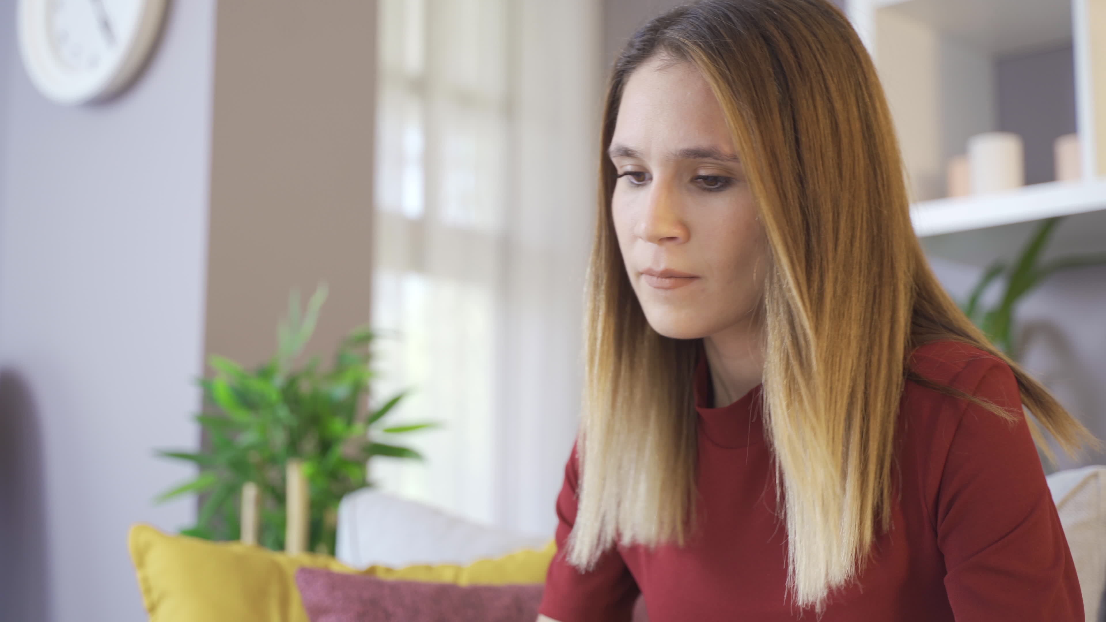 A woman grits her teeth then screams as she strains and pushes. Young