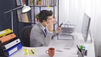 Angry businessman wearing suit and thinking thoughtfully on the phone. Office worker making an annoying phone call.