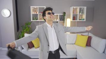 Businessman is happy and dancing at home. Coming home from work. The businessman coming home from work is happy and dancing. video