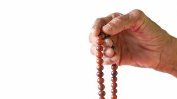 Mature hand holding to a bead necklace video