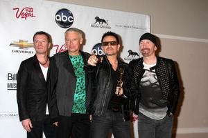 LAS VEGAS, MAY 22 - U2 Larry Mullen Jr, Adam Clayton, Bono and The Edge in the Press Room of the 2011 Billboard Music Awards at MGM Grand Garden Arena on May 22, 2010 in Las Vegas, NV photo