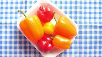 A tray of bell peppers, red yellow and orange video